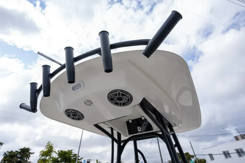 Slide: The Image of 2025 Pathfinder 2400 Open boat with rod holders and speakers under a cloudy sky. - 9