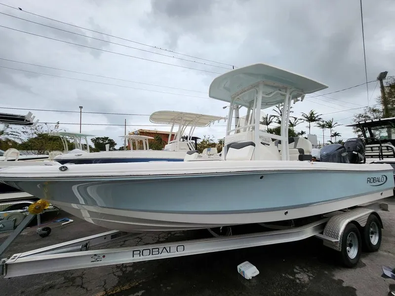 Slide: The Image of 2023 Robalo 226 Cayman boat on trailer, overcast sky background. - 10