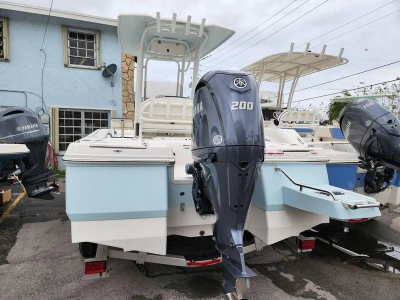 Slide: The Image of 2023 Robalo 226 Cayman boat with Yamaha 200 outboard motor, parked outdoors. - 7