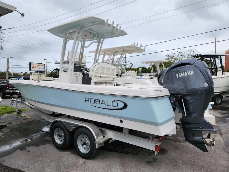 Slide: The Image of 2023 Robalo 226 Cayman boat with Yamaha engine on trailer, parked outdoors. - 8