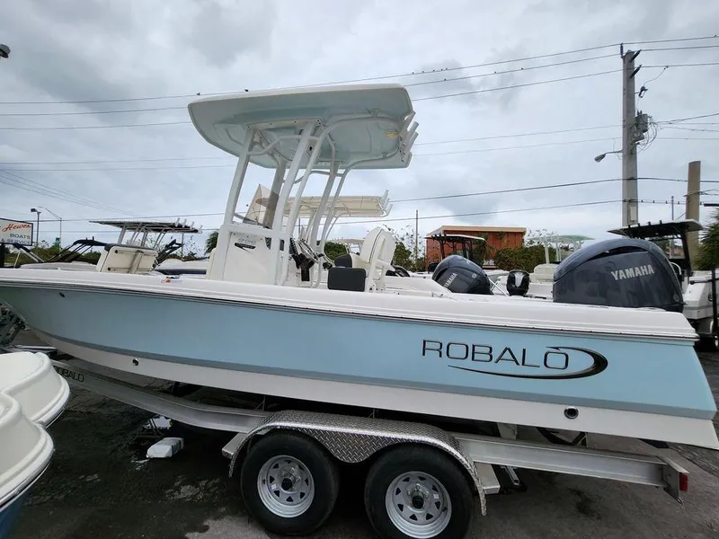 Slide: The Image of 2023 Robalo 226 Cayman boat on trailer, side view, with Yamaha engines. - 9