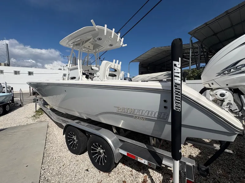 Slide: The Image of 2024 Pathfinder 2700 Open boat on trailer, displayed outdoors under clear sky. - 7