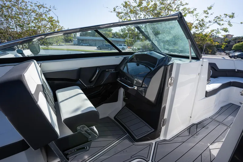 Slide: The Image of 2023 Monterey 275SS boat interior with sleek seating and modern dashboard design. - 12