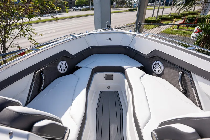 Slide: The Image of 2023 Monterey 275SS boat interior with white seating and speakers. - 16