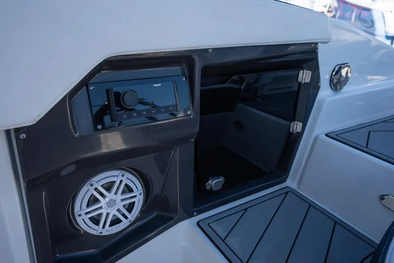 Slide: The Image of 2023 Monterey 275SS boat interior with audio system and storage compartment. - 20