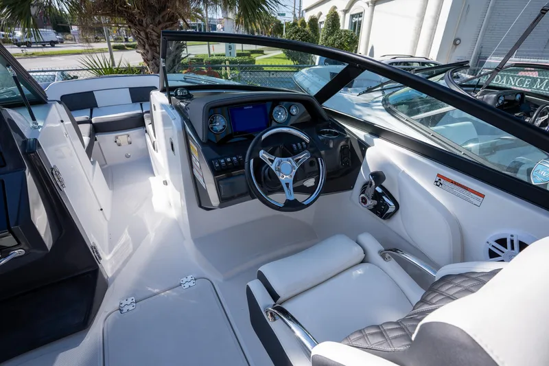 Slide: The Image of 2023 Monterey 275SS boat interior with modern dashboard and steering wheel. - 23