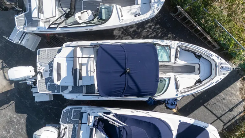 Slide: The Image of 2023 Monterey 275SS boat, aerial view, docked with cover, surrounded by other boats. - 6