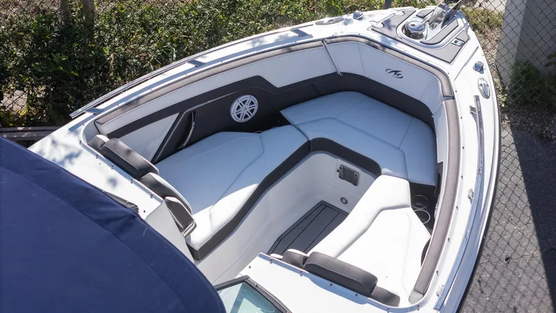 Slide: The Image of 2023 Monterey 275SS boat interior with white and gray seating, outdoor setting. - 8
