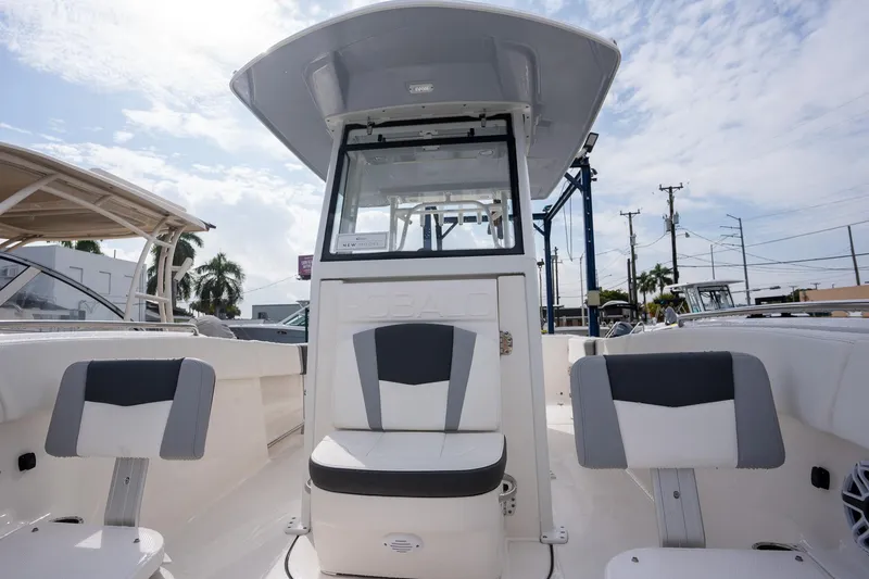 Slide: The Image of 2025 Robalo R270 boat interior with seating, under a clear blue sky. - 14