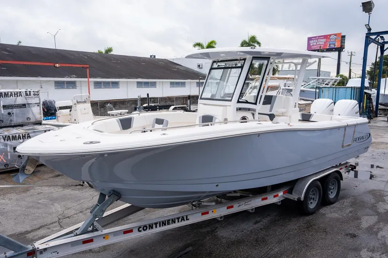 Slide: The Image of 2025 Robalo R270 boat on trailer, sleek design, parked outdoors. - 5
