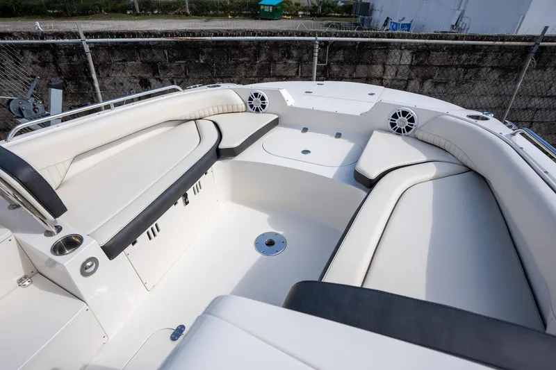 Slide: The Image of 2024 Stingray 212SC boat interior with white seating and speaker system. - 3