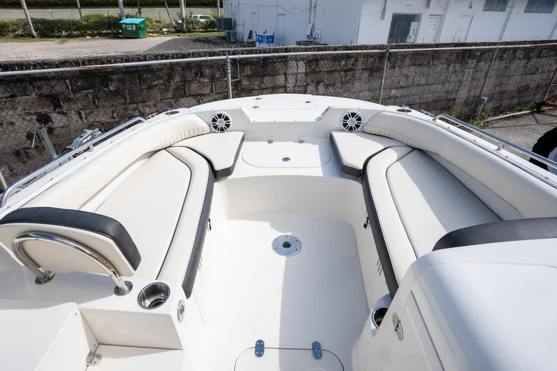 Slide: The Image of 2024 Stingray 212SC boat interior with white seating and cup holders. - 4