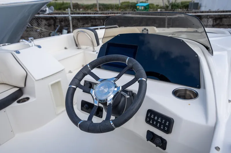 Slide: The Image of 2024 Stingray 212SC boat steering wheel and dashboard, featuring modern controls and sleek design. - 7