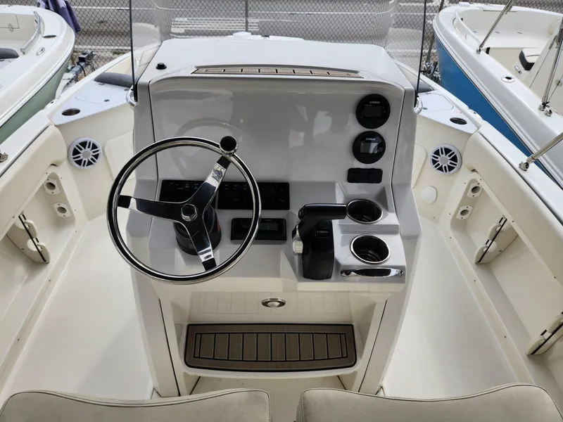 Slide: The Image of 2023 Stingray 206cc boat cockpit with steering wheel and controls. - 10
