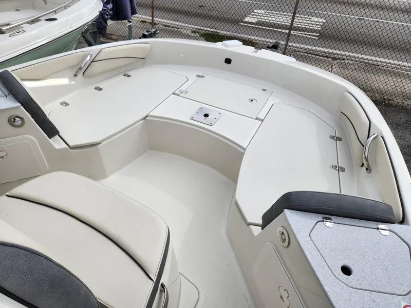 Slide: The Image of 2023 Stingray 206cc boat interior with white seating and storage compartments. - 11