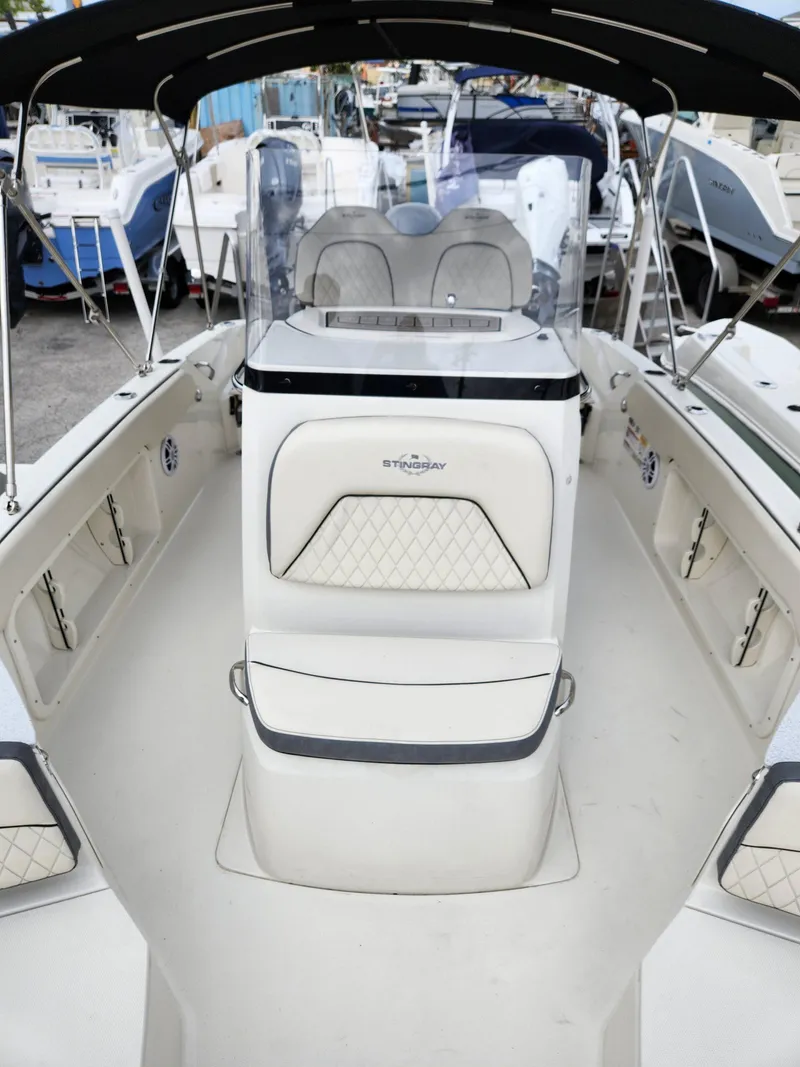 Slide: The Image of 2023 Stingray 206cc boat interior with seating and console, featuring a sleek design. - 14