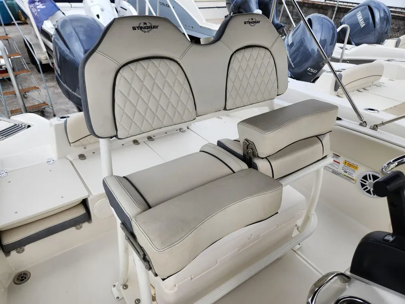Slide: The Image of 2023 Stingray 206cc boat interior with cushioned seating and Yamaha engines. - 16