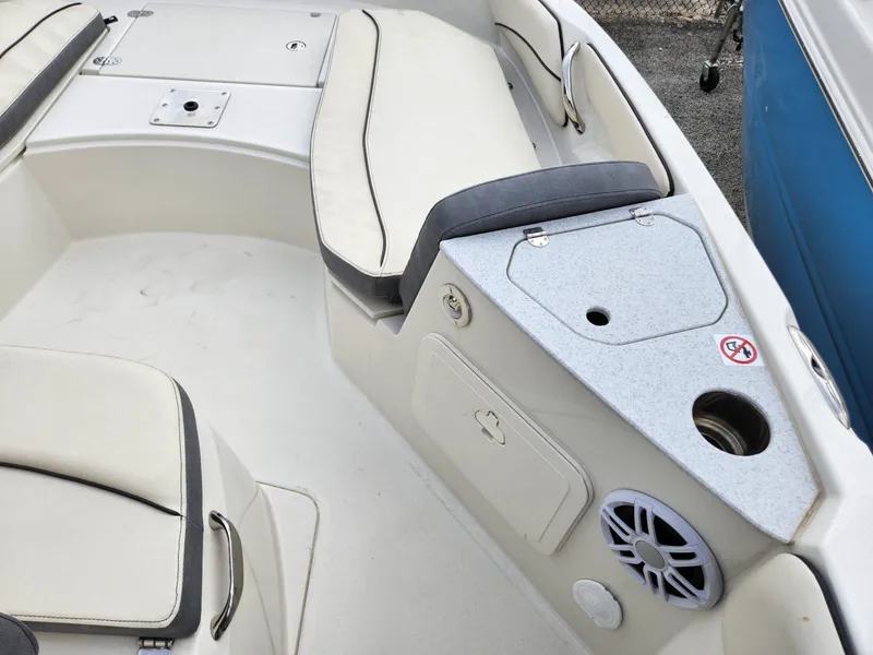 Slide: The Image of 2023 Stingray 206cc boat interior with cushioned seating and storage compartments. - 19
