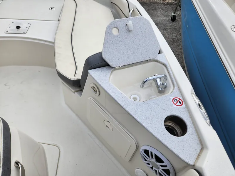 Slide: The Image of 2023 Stingray 206cc boat interior with sink and seating area. - 20