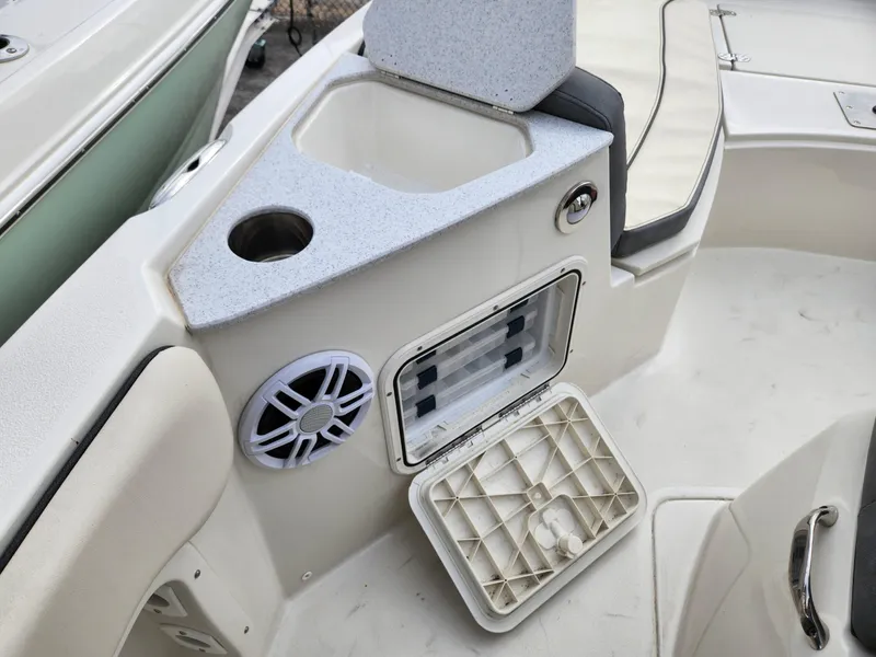 Slide: The Image of 2023 Stingray 206cc boat interior with storage compartment and speaker. - 22