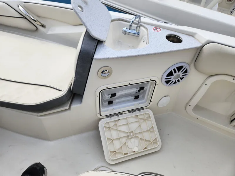 Slide: The Image of 2023 Stingray 206cc boat interior with sink, storage compartment, and speaker. - 23