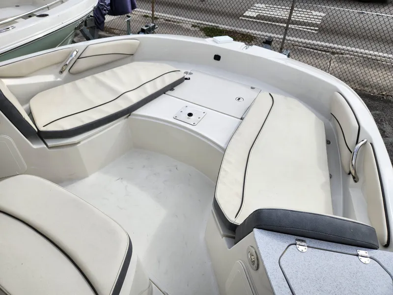 Slide: The Image of 2023 Stingray 206cc boat interior with cushioned seating and storage compartments. - 24