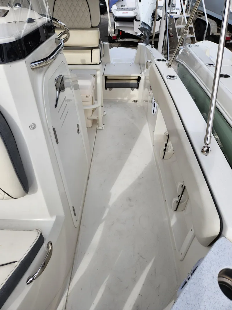 Slide: The Image of 2023 Stingray 206cc boat interior with white seating and sleek design. - 31