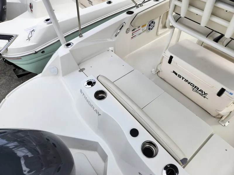 Slide: The Image of 2023 Stingray 206cc boat interior with seating and storage compartments. - 7