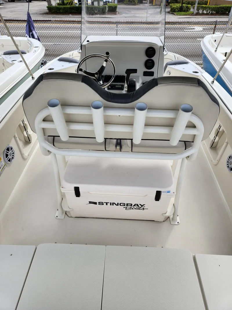 Slide: The Image of 2023 Stingray 206cc boat interior with steering console and rod holders. - 8