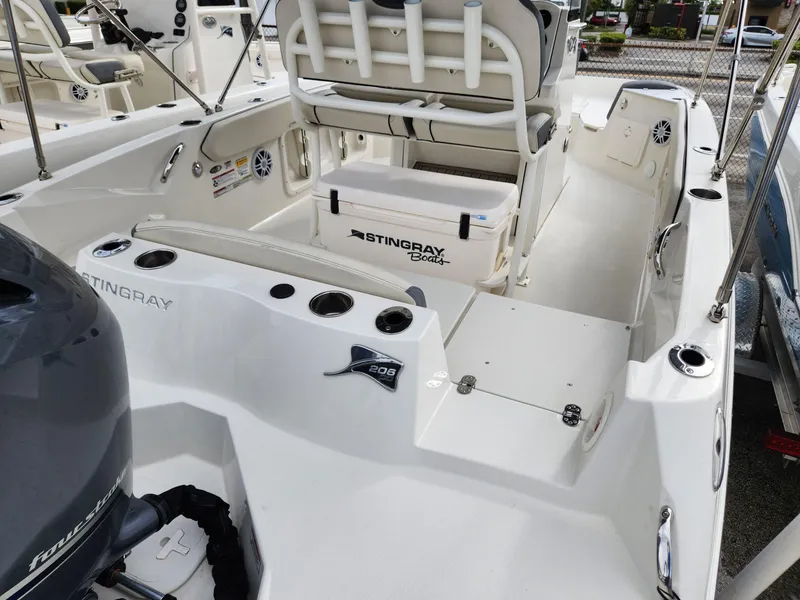 Slide: The Image of 2023 Stingray 206cc boat interior with seating and storage features. - 9