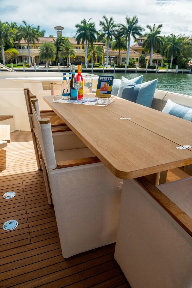 Slide: The Image of Luxury outdoor dining area on 2020 Ferretti Yachts 670, featuring elegant table and chairs. - 10