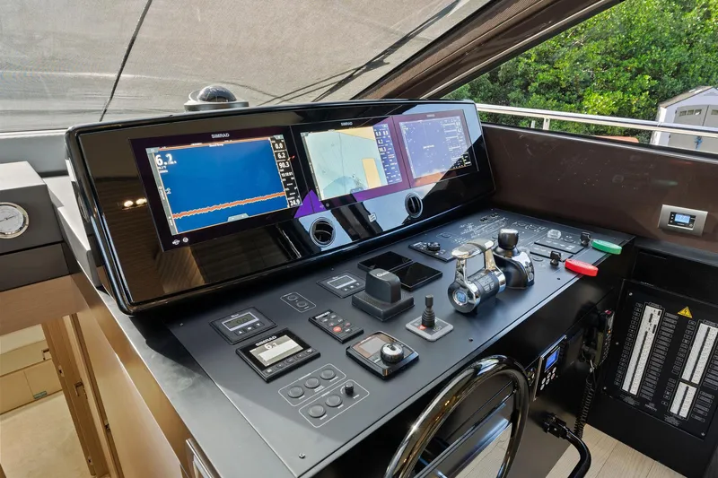 Slide: The Image of Control panel of a 2020 Ferretti Yachts 670, featuring advanced navigation displays and controls. - 30