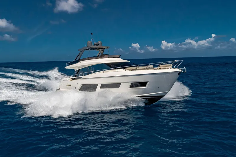 Slide: The Image of 2020 Ferretti Yachts 670 cruising on open sea under clear blue sky. - 4