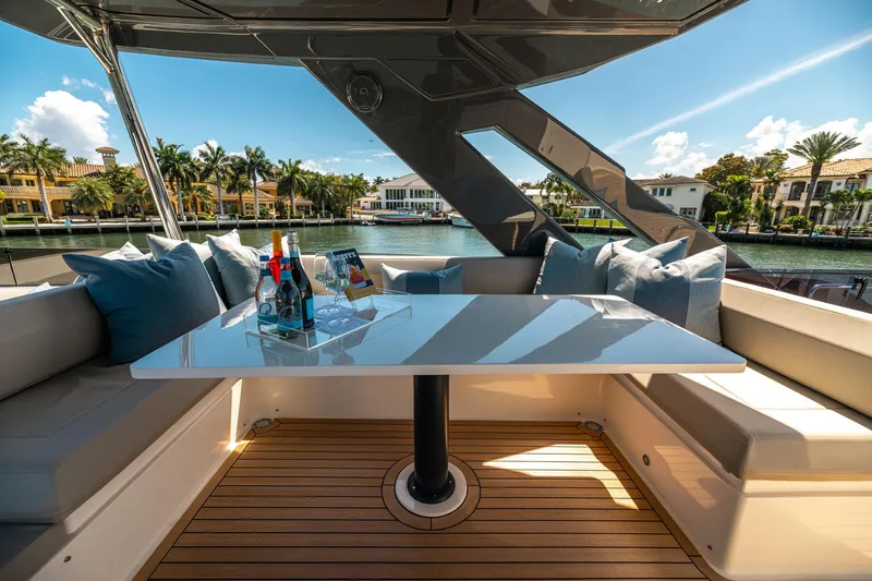 Slide: The Image of Luxurious Ferretti Yachts 670 deck with elegant seating and scenic waterfront view, 2020 model. - 5