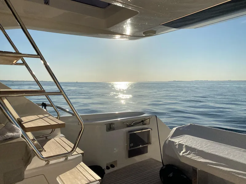 Slide: The Image of 2020 Ferretti Yachts 670, sunlit deck view over calm ocean waters. - 6