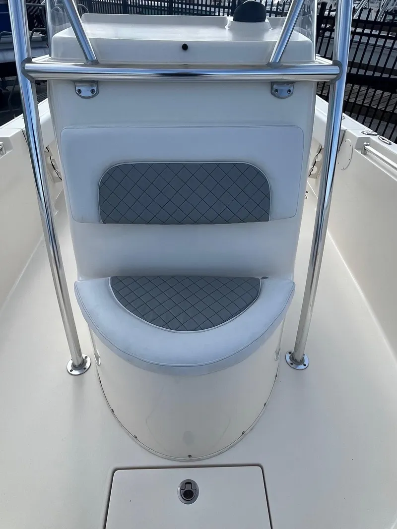Slide: The Image of 2022 Cobia 237 Center Console boat seating area with stainless steel railings. - 7