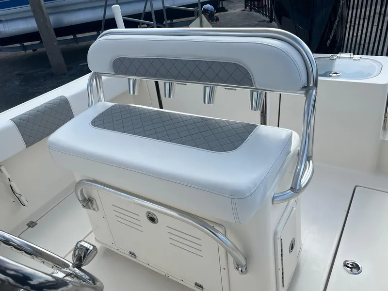 Slide: The Image of 2022 Cobia 237 Center Console boat with cushioned seating and storage. - 8
