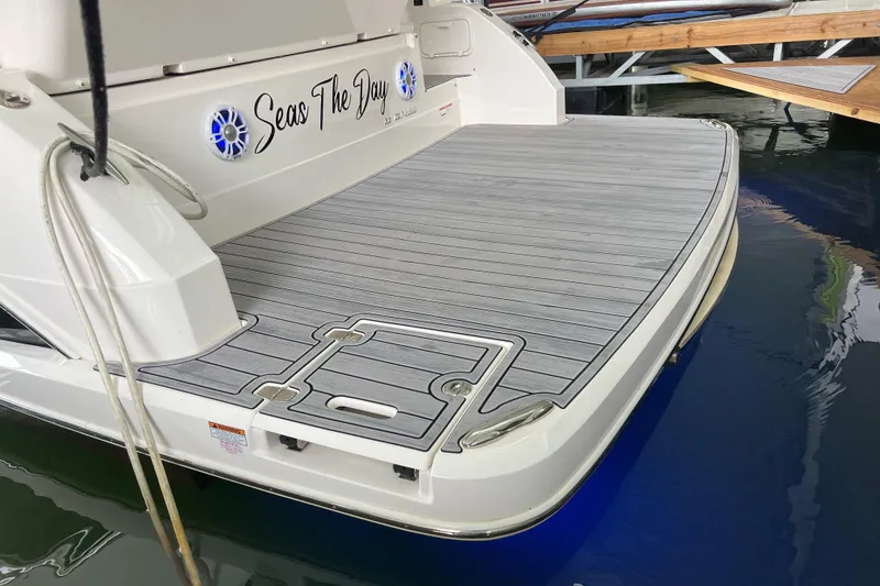 Slide: The Image of 2019 Regal 33 Express yacht with "Seas The Day" on the deck at a marina. - 11