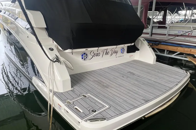 Slide: The Image of 2019 Regal 33 Express yacht with "Seas The Day" name, docked in a marina. - 12