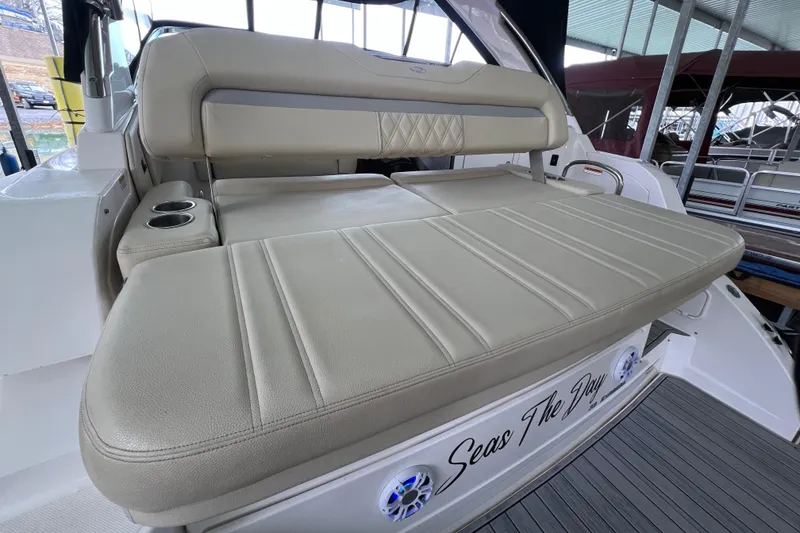 Slide: The Image of 2019 Regal 33 Express boat with beige seating and cup holders. - 17