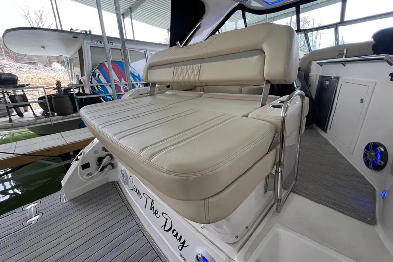 Slide: The Image of 2019 Regal 33 Express boat with beige seating in a marina setting. - 18