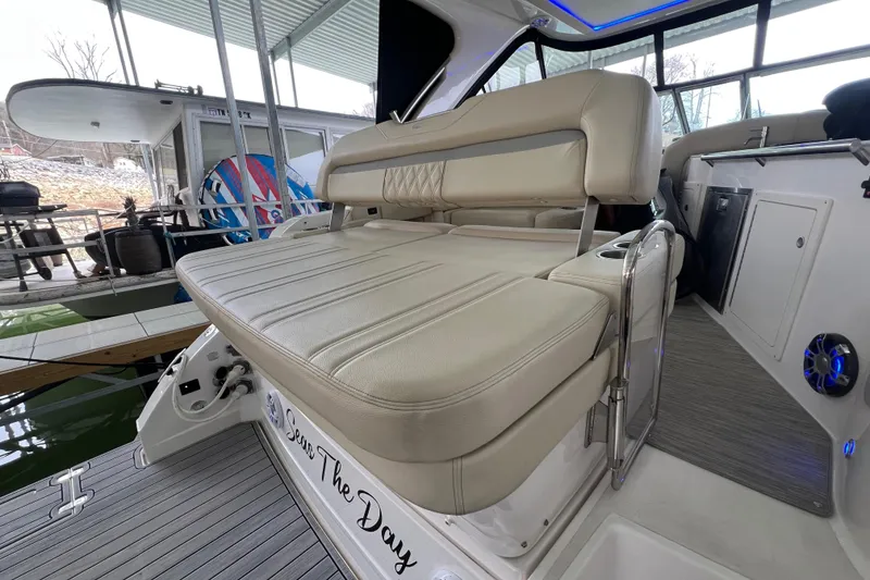 Slide: The Image of 2019 Regal 33 Express boat with beige seating in a marina setting. - 19