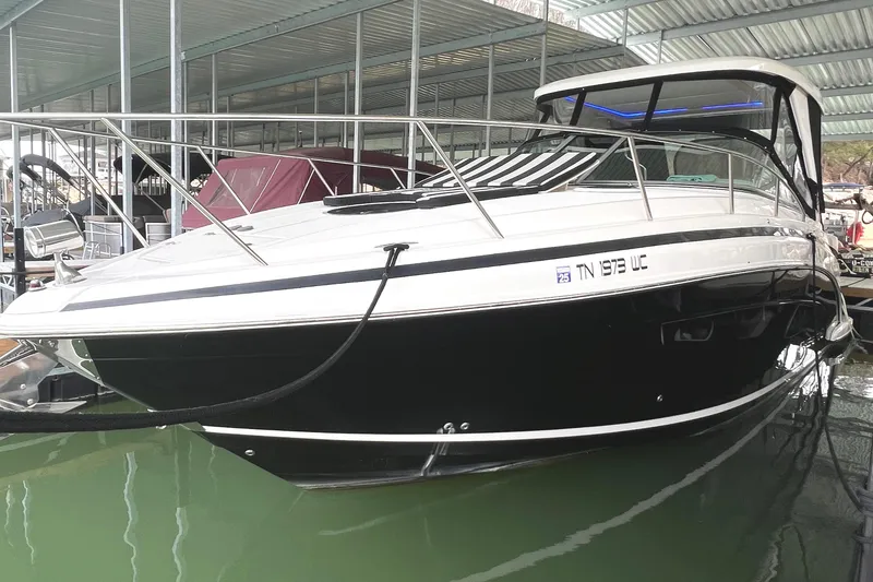 Slide: The Image of 2019 Regal 33 Express boat docked in a covered marina. - 2