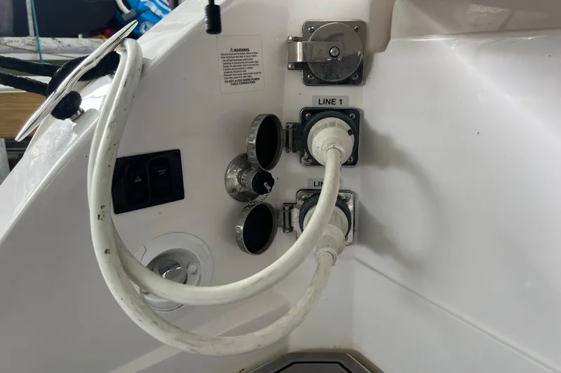 Slide: The Image of 2019 Regal 33 Express boat power connections and control panel. - 20