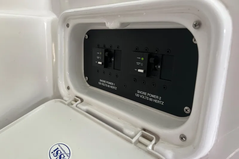 Slide: The Image of Electrical panel on a 2019 Regal 33 Express boat, showing shore power switches. - 21