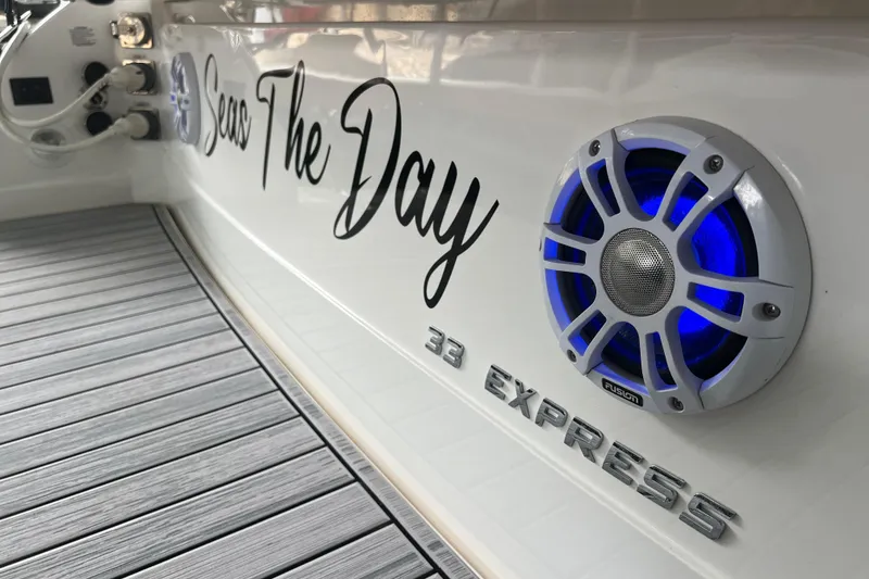 Slide: The Image of 2019 Regal 33 Express boat with custom lettering and blue-lit speaker. - 22