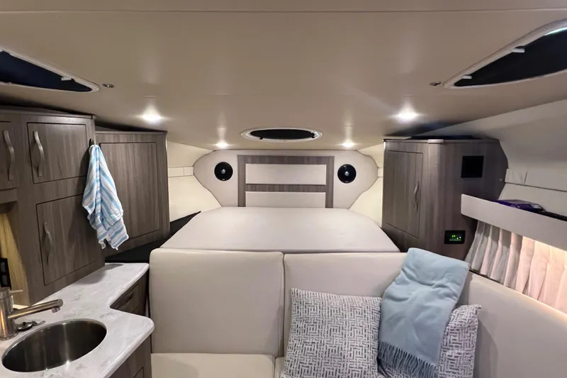 Slide: The Image of 2019 Regal 33 Express cabin interior with modern amenities and cozy seating. - 25