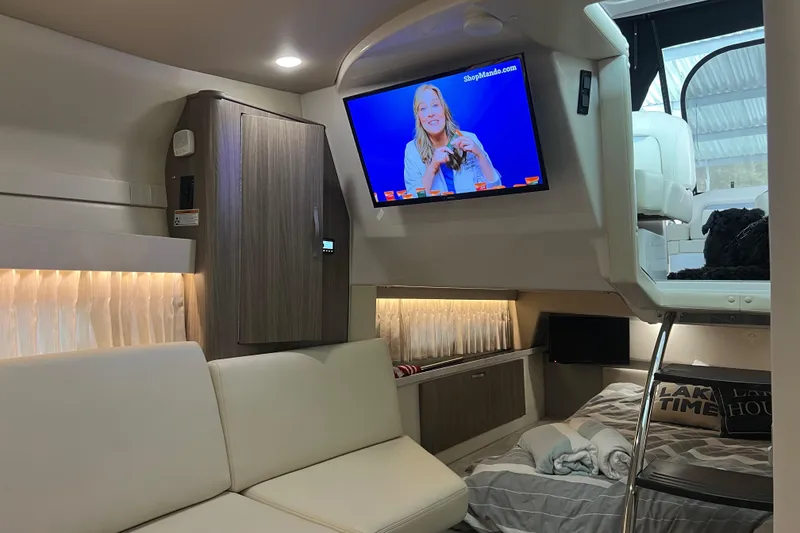 Slide: The Image of Interior of a 2019 Regal 33 Express yacht with modern furnishings and a mounted TV. - 28
