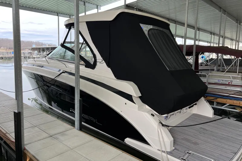 Slide: The Image of 2019 Regal 33 Express boat docked under covered marina. - 3