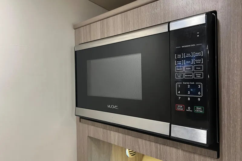 Slide: The Image of Built-in microwave in 2019 Regal 33 Express boat kitchen. - 36